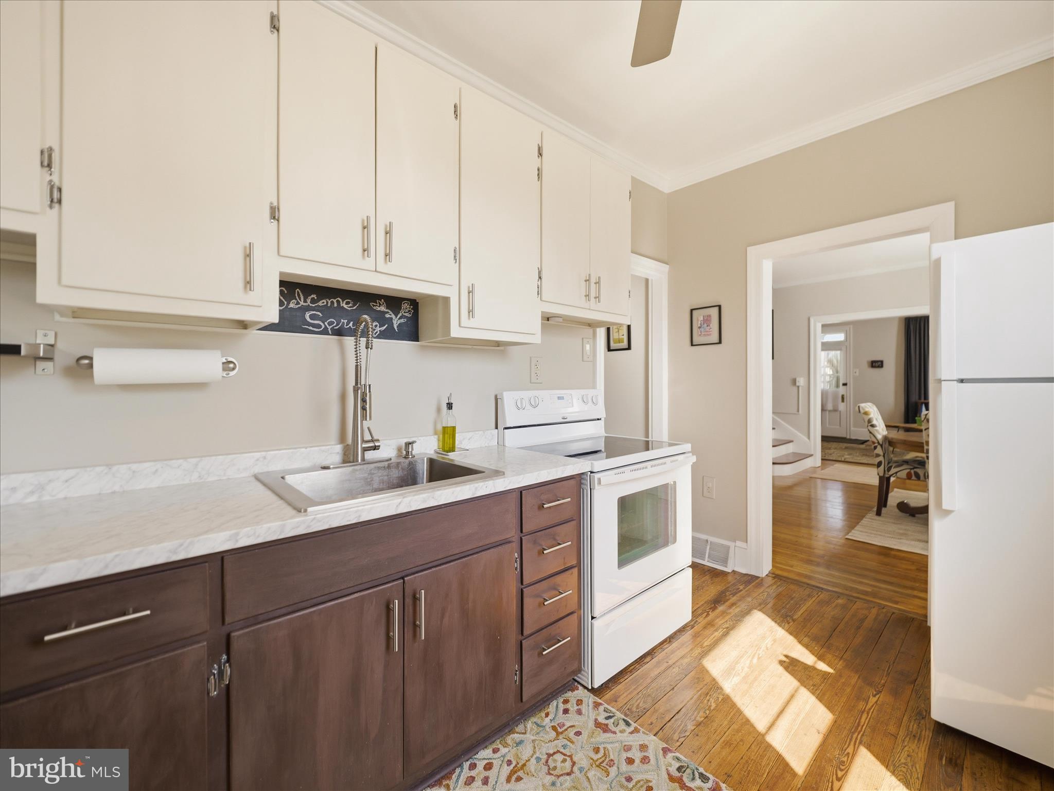 14 South High Street Funkstown, MD 21734 - Photo 13 of 33 a kitchen with a sink dishwasher and white cabinets with wooden floor