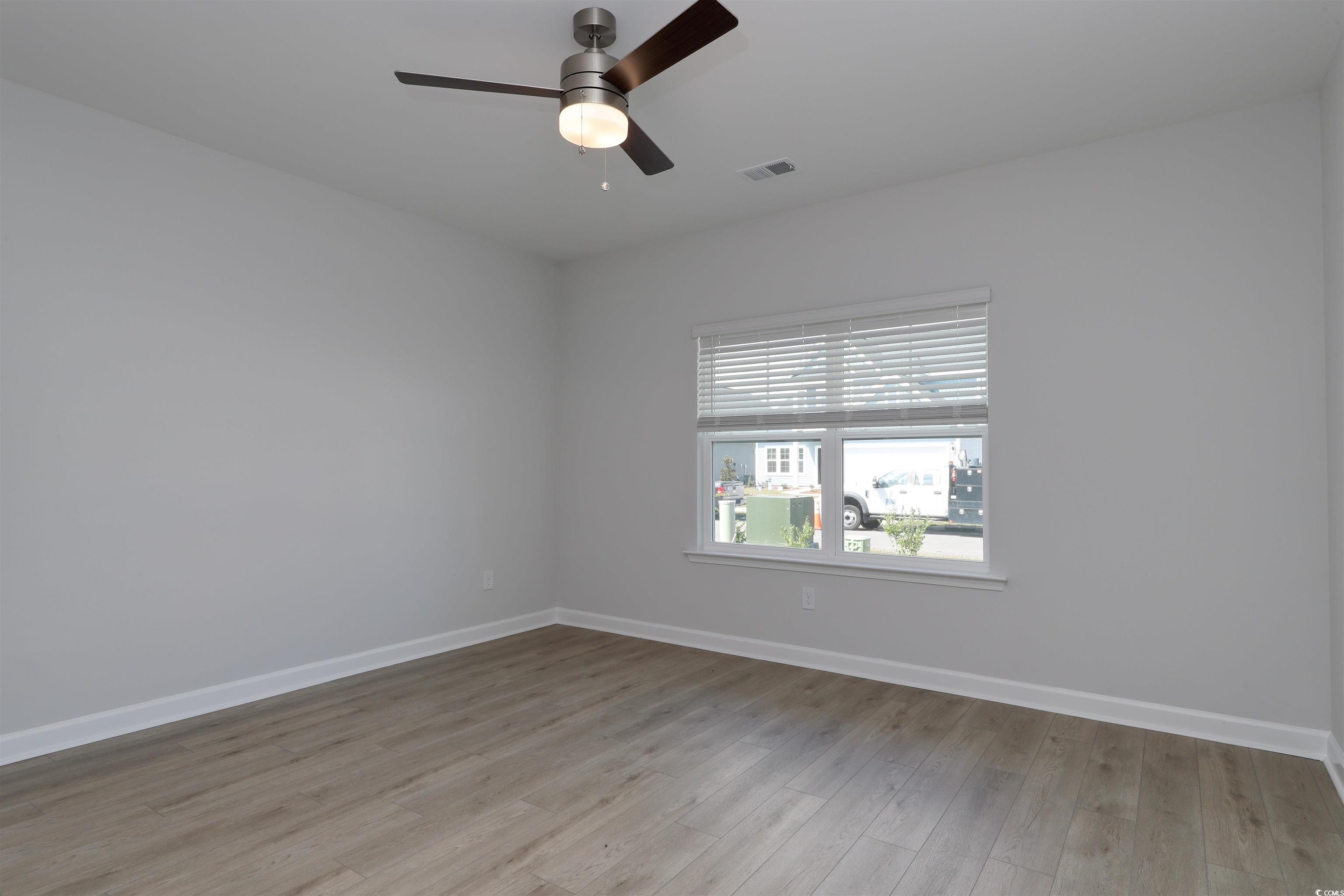 1083 Laconic Drive Myrtle Beach, SC 29588 - Photo 12 of 40 Spare room featuring light wood finished floors and ceiling fan