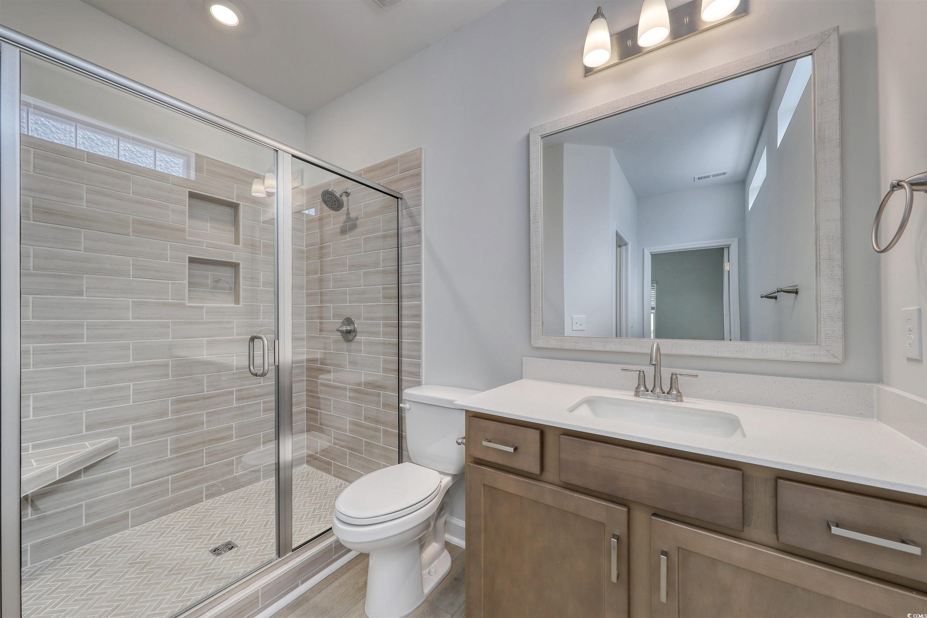 1083 Laconic Drive Myrtle Beach, SC 29588 - Photo 14 of 40 Bathroom with vanity, a shower stall, and recessed lighting