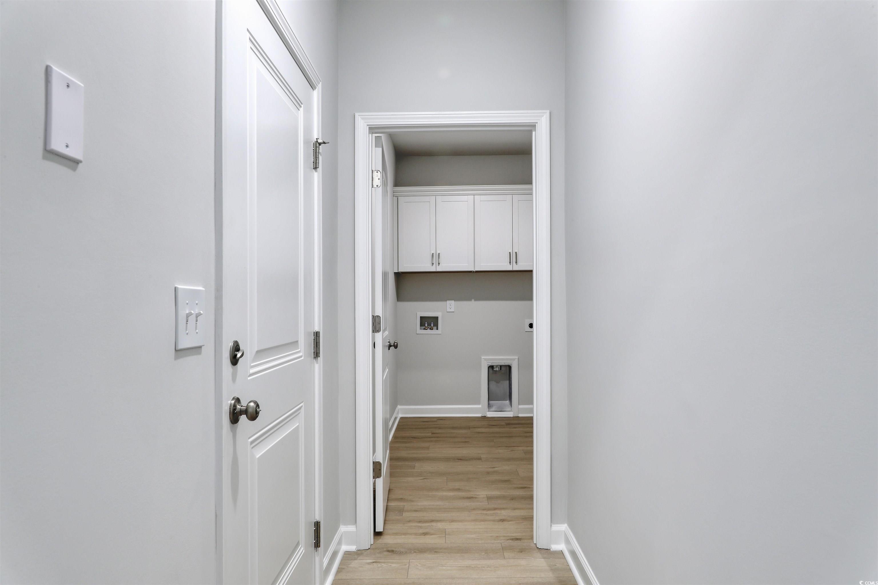 1083 Laconic Drive Myrtle Beach, SC 29588 - Photo 16 of 40 Laundry area with light wood-style flooring, hookup for an electric dryer, cabinet space, and washer hookup