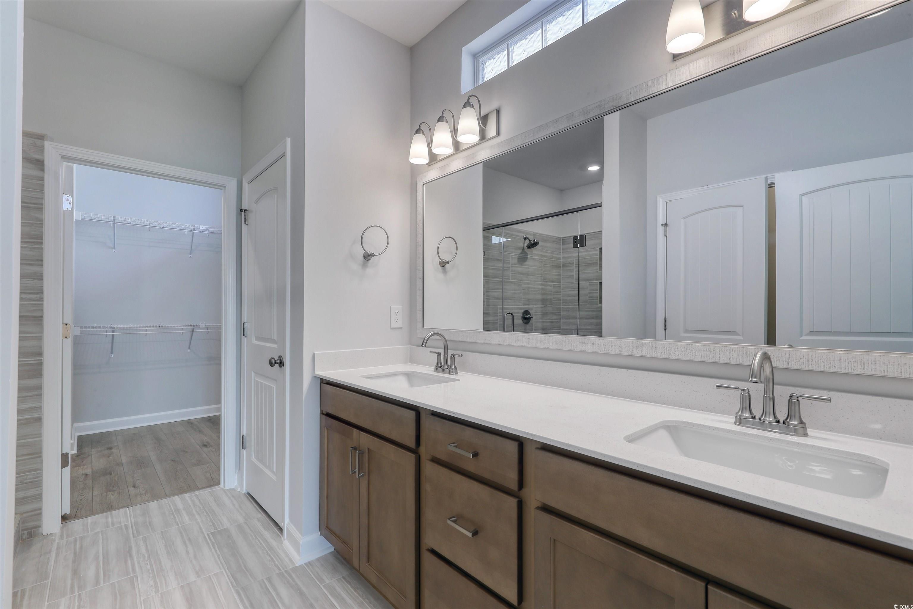 1083 Laconic Drive Myrtle Beach, SC 29588 - Photo 20 of 40 Full bath featuring a stall shower, double vanity, and a spacious closet