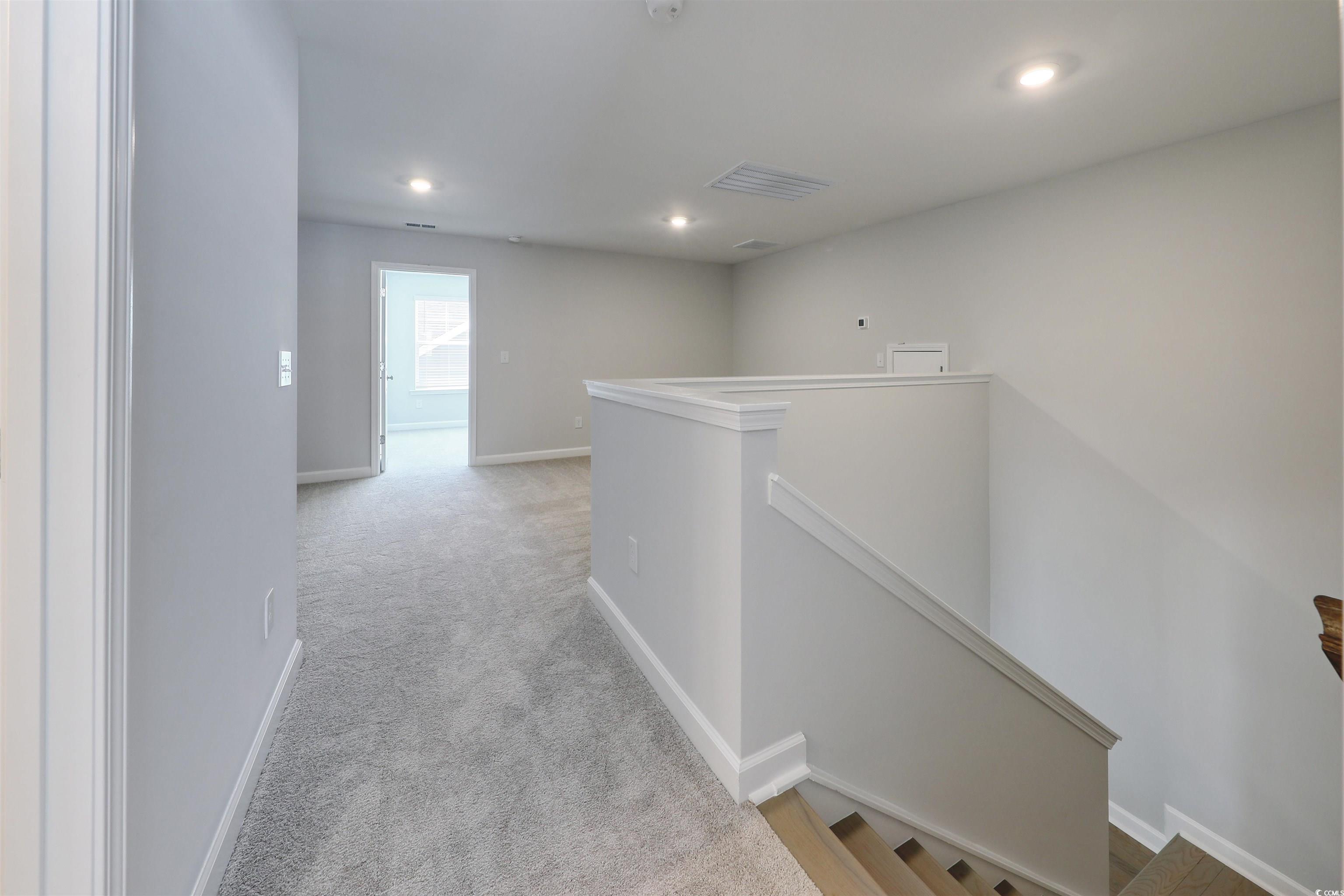 1083 Laconic Drive Myrtle Beach, SC 29588 - Photo 25 of 40 Hall featuring an upstairs landing, light colored carpet, and recessed lighting