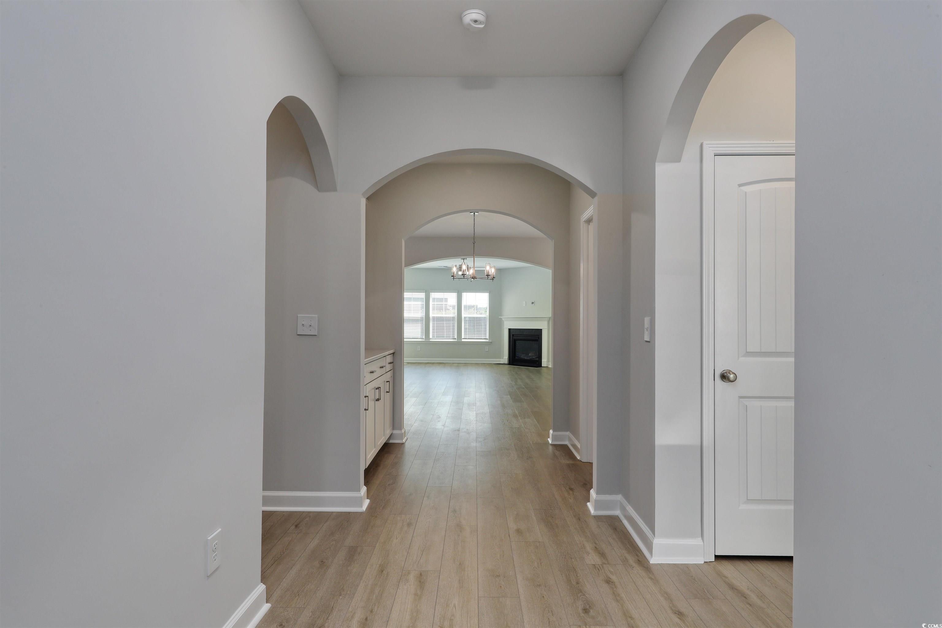 1083 Laconic Drive Myrtle Beach, SC 29588 - Photo 4 of 40 Corridor with a chandelier and light wood-style flooring