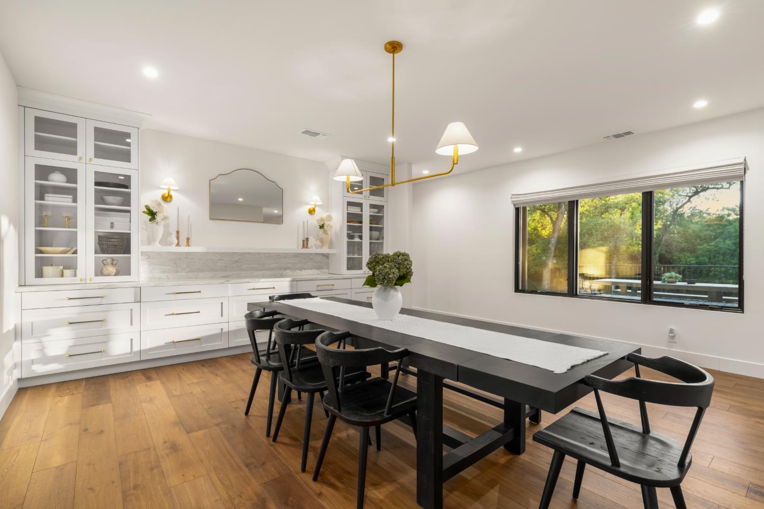 7697 Horseshoe Bar Road Loomis, CA 95650 - Photo 21 of 76 a kitchen with kitchen island a dining table chairs and white cabinets