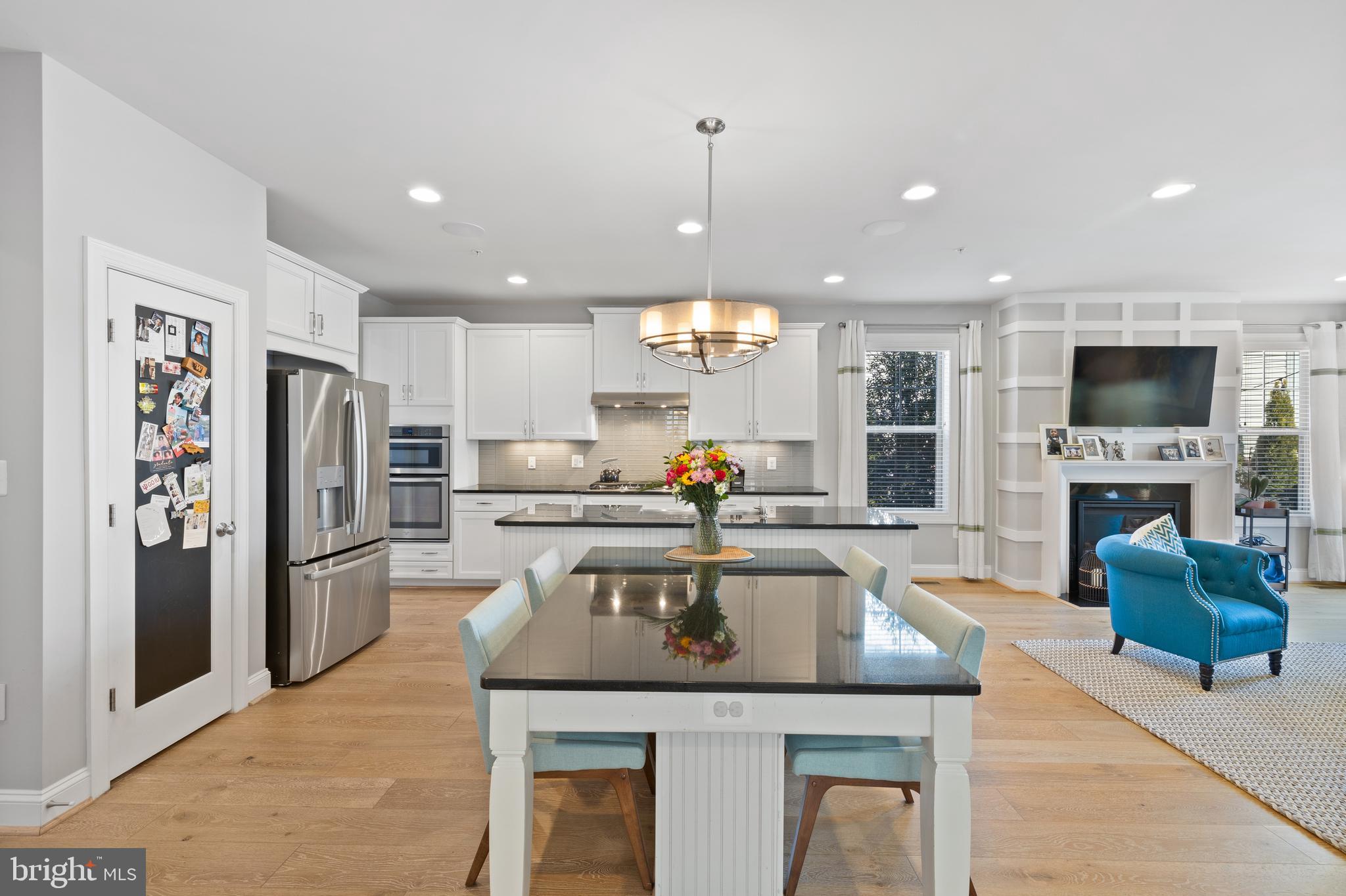 13410 Redspire Drive Silver Spring, MD 20906 - Photo 12 of 43 a kitchen with a refrigerator a stove a sink dishwasher and oven with wooden floor
