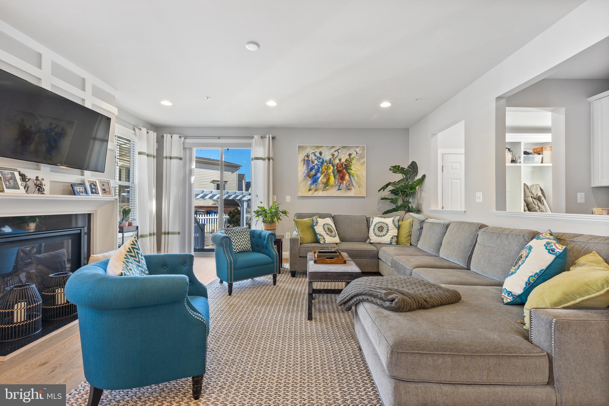 13410 Redspire Drive Silver Spring, MD 20906 - Photo 15 of 43 a living room with furniture a flat screen tv and a fireplace