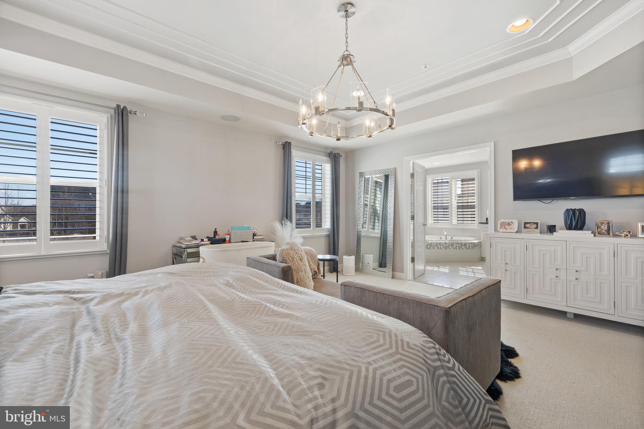 13410 Redspire Drive Silver Spring, MD 20906 - Photo 17 of 43 a large bedroom with a large bed a flat tv screen and a large window