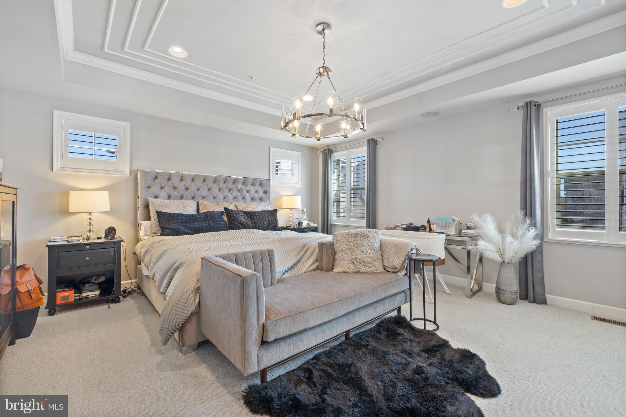 13410 Redspire Drive Silver Spring, MD 20906 - Photo 18 of 43 a bedroom with a bed and a chandelier