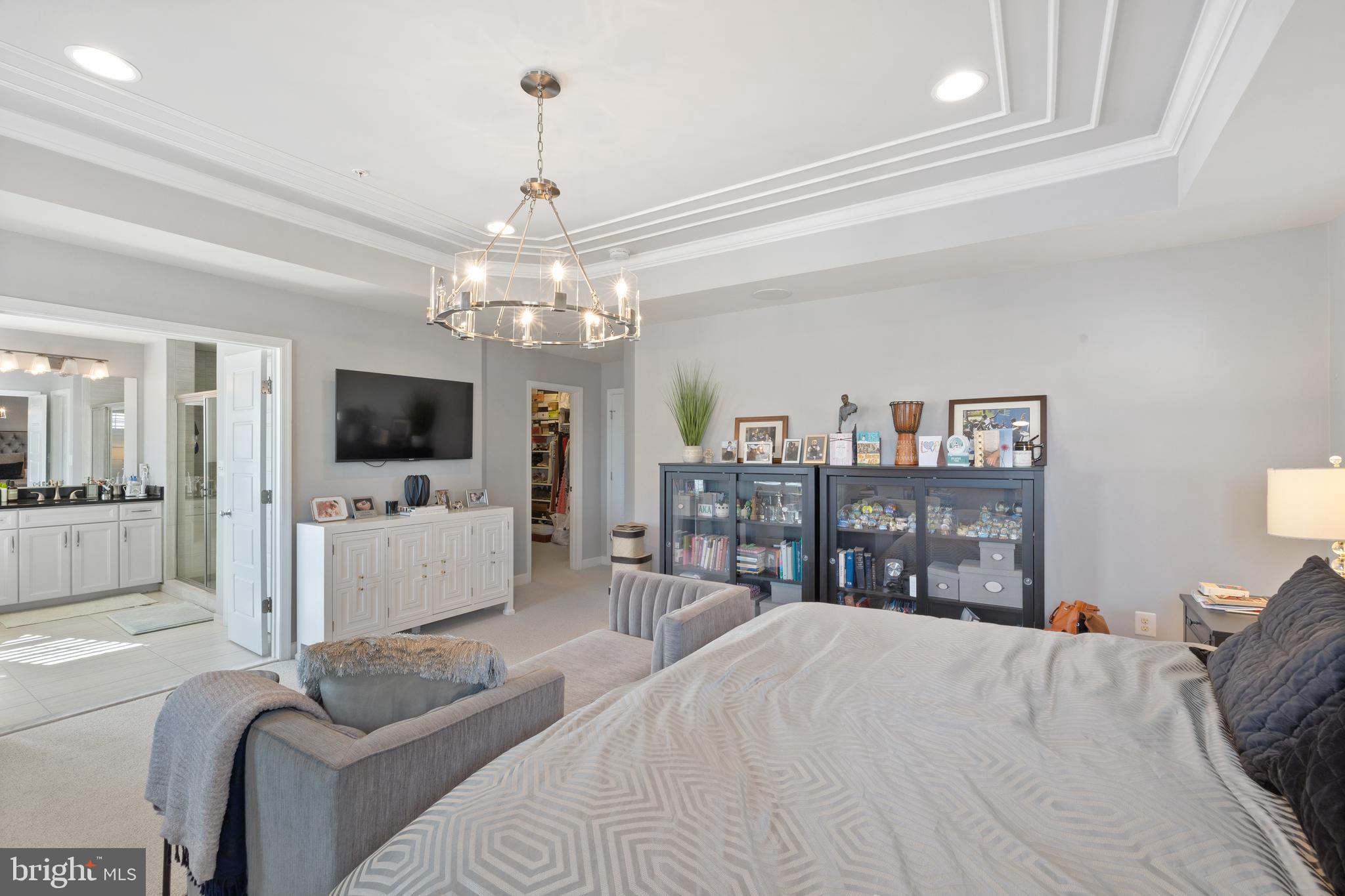 13410 Redspire Drive Silver Spring, MD 20906 - Photo 19 of 43 a large bedroom with a bed and a flat screen tv