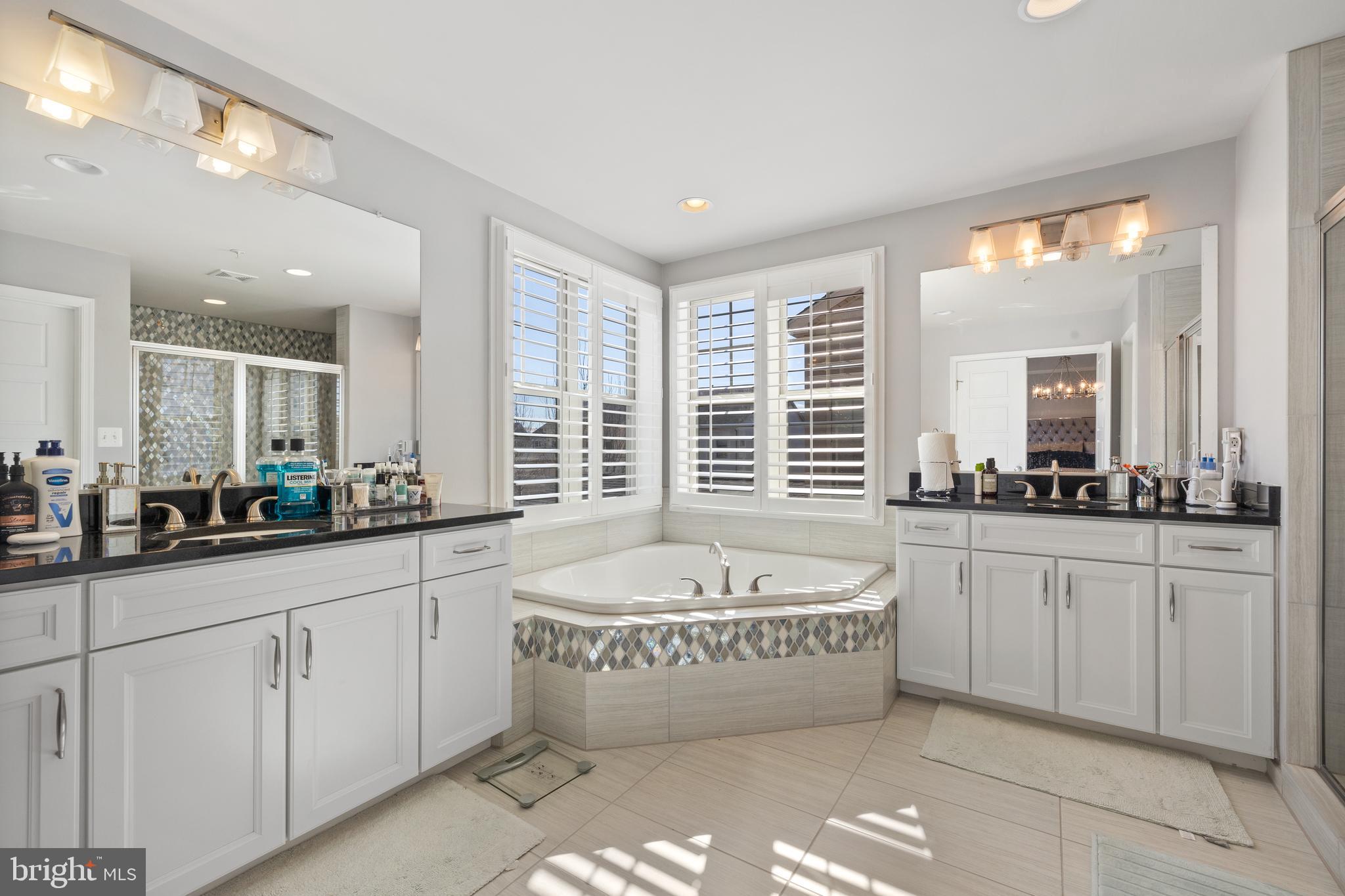 13410 Redspire Drive Silver Spring, MD 20906 - Photo 20 of 43 a spacious bathroom with sinks mirror and a bathtub