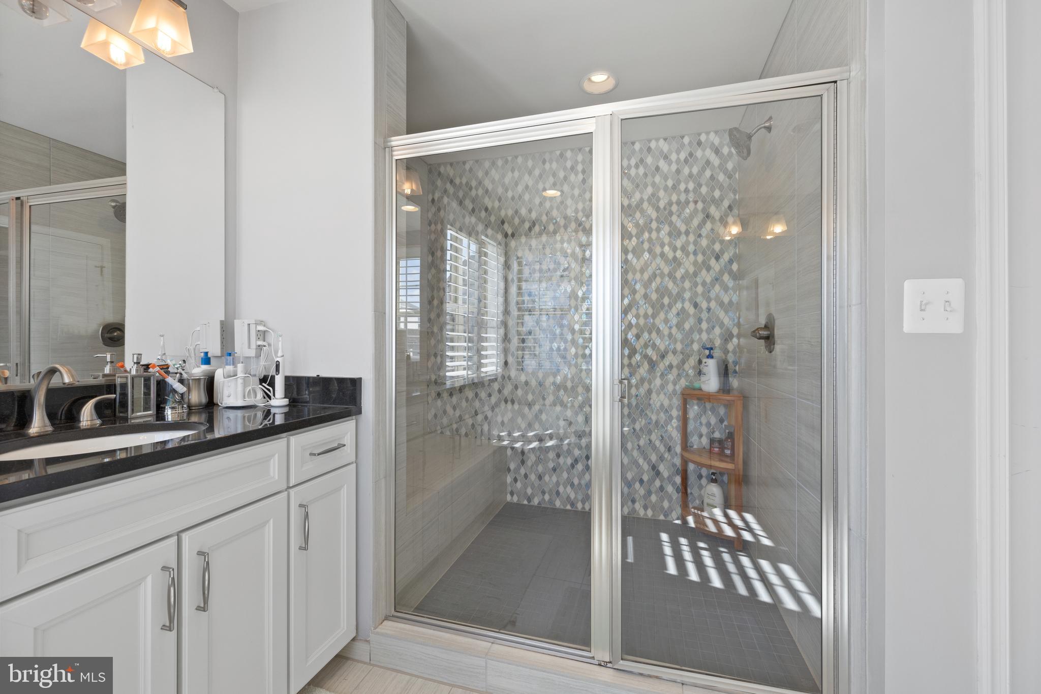 13410 Redspire Drive Silver Spring, MD 20906 - Photo 21 of 43 a bathroom with a shower sink and mirror