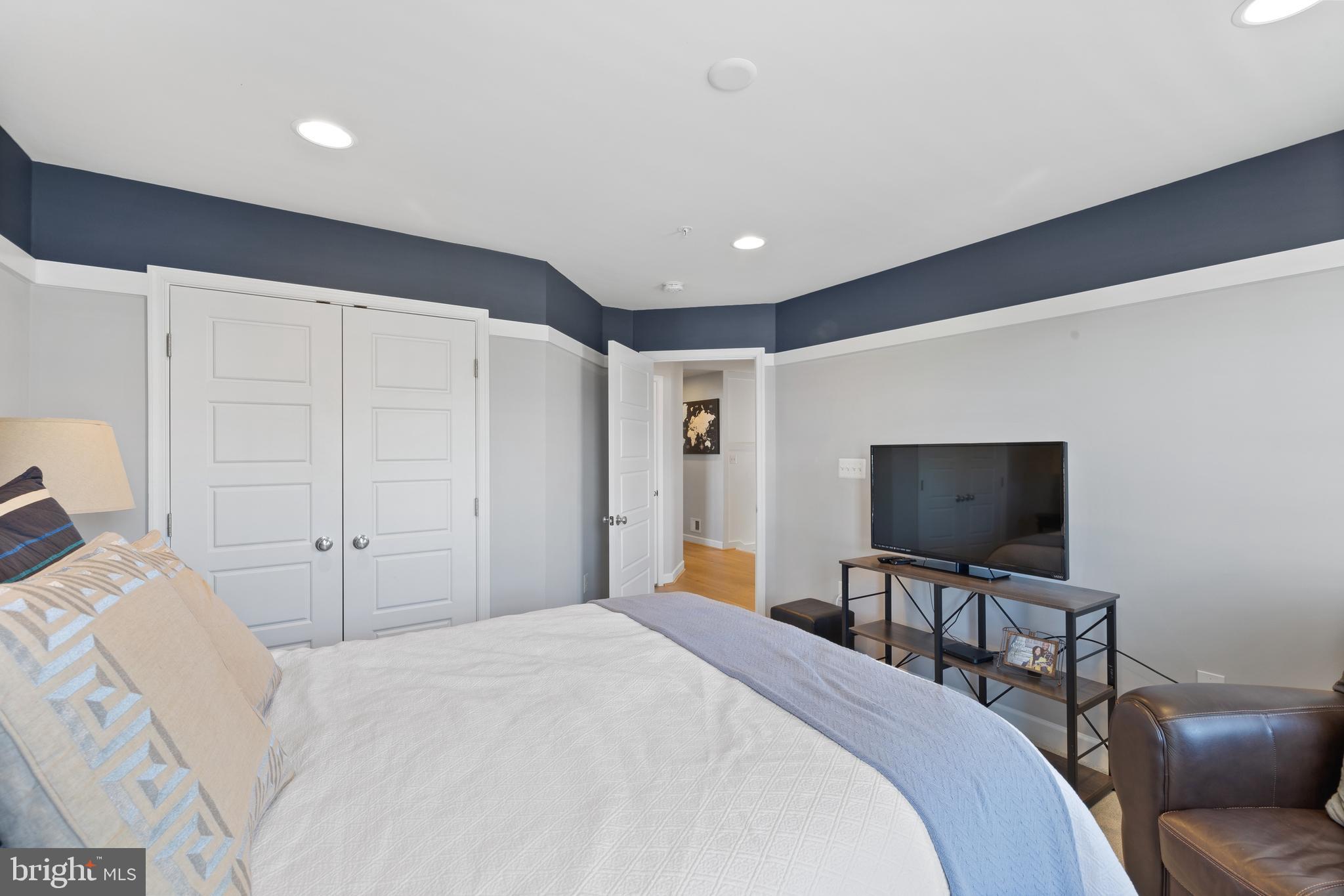 13410 Redspire Drive Silver Spring, MD 20906 - Photo 23 of 43 a bedroom with a bed and a flat screen tv