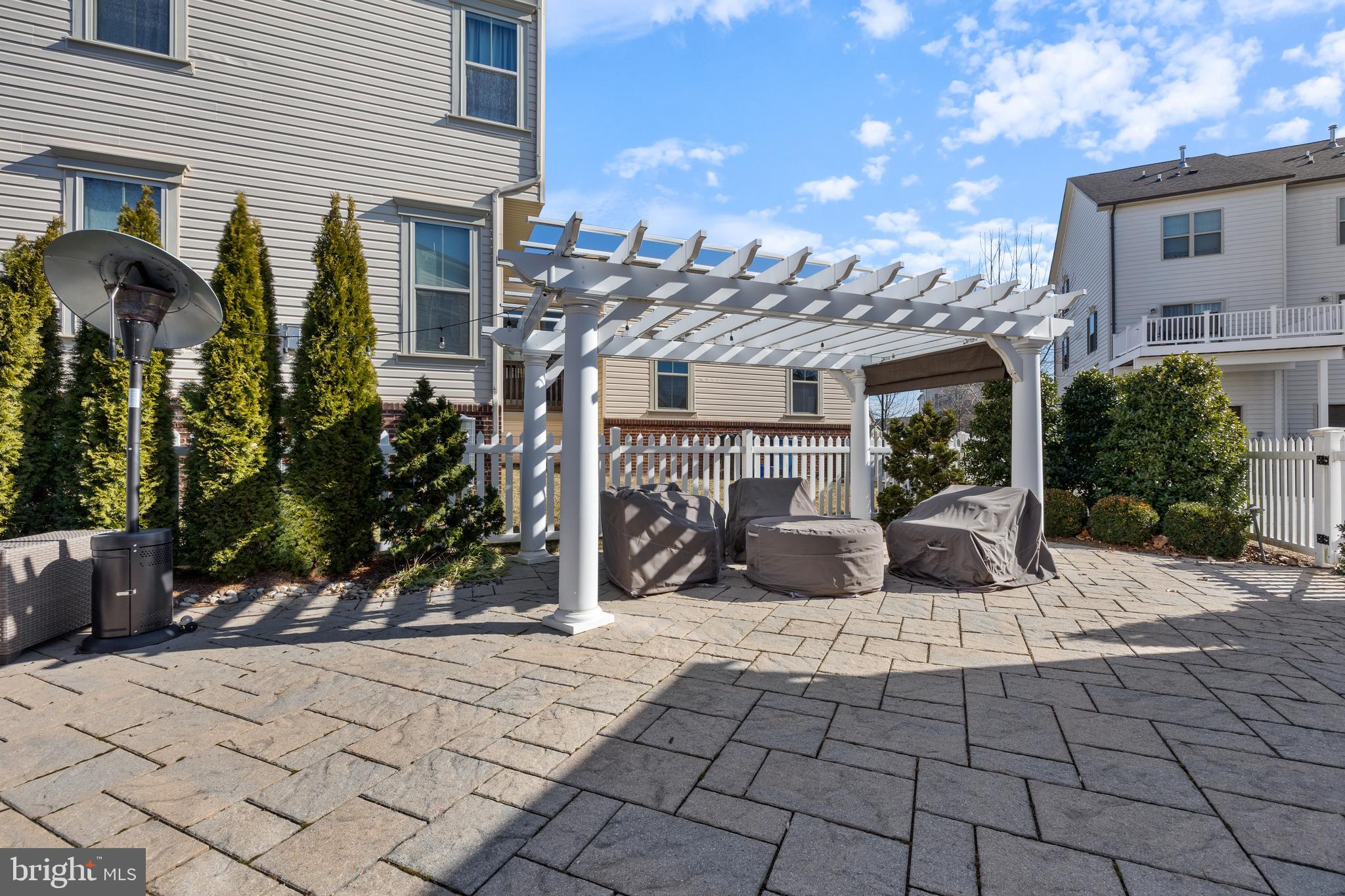 13410 Redspire Drive Silver Spring, MD 20906 - Photo 40 of 43 a view of a patio with table and chairs potted plants and palm trees