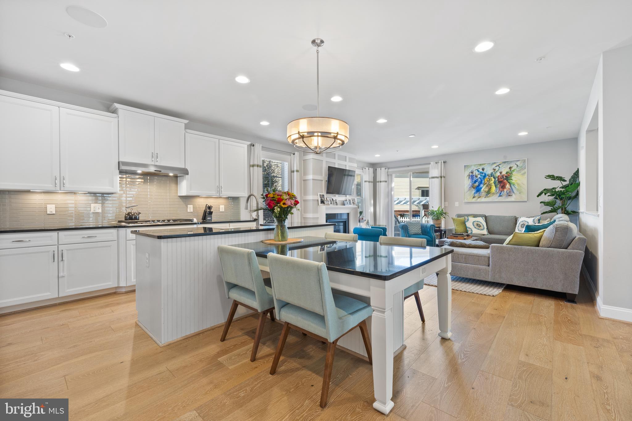13410 Redspire Drive Silver Spring, MD 20906 - Photo 5 of 43 a kitchen with counter space dining table and stainless steel appliances