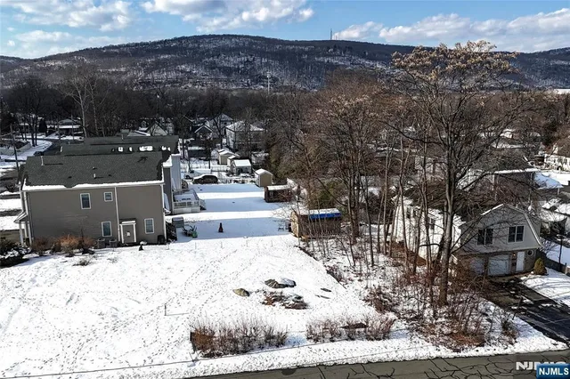 an aerial view of a house with a yard and sitting area
