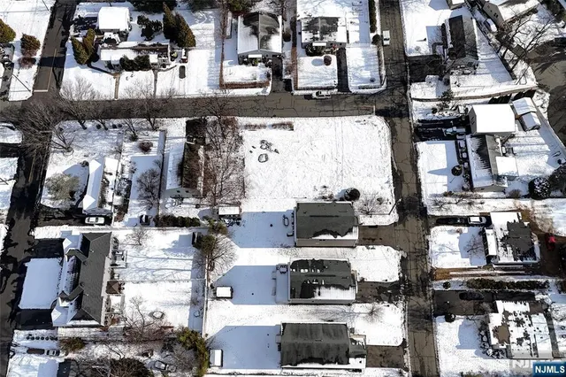 a view of a house with snow on the road