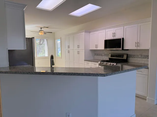 a kitchen with stainless steel appliances a refrigerator sink and cabinets