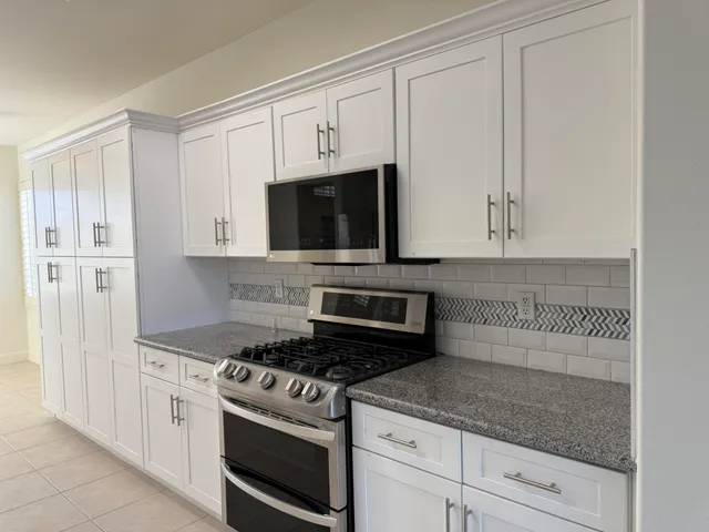 a kitchen with a refrigerator and a sink