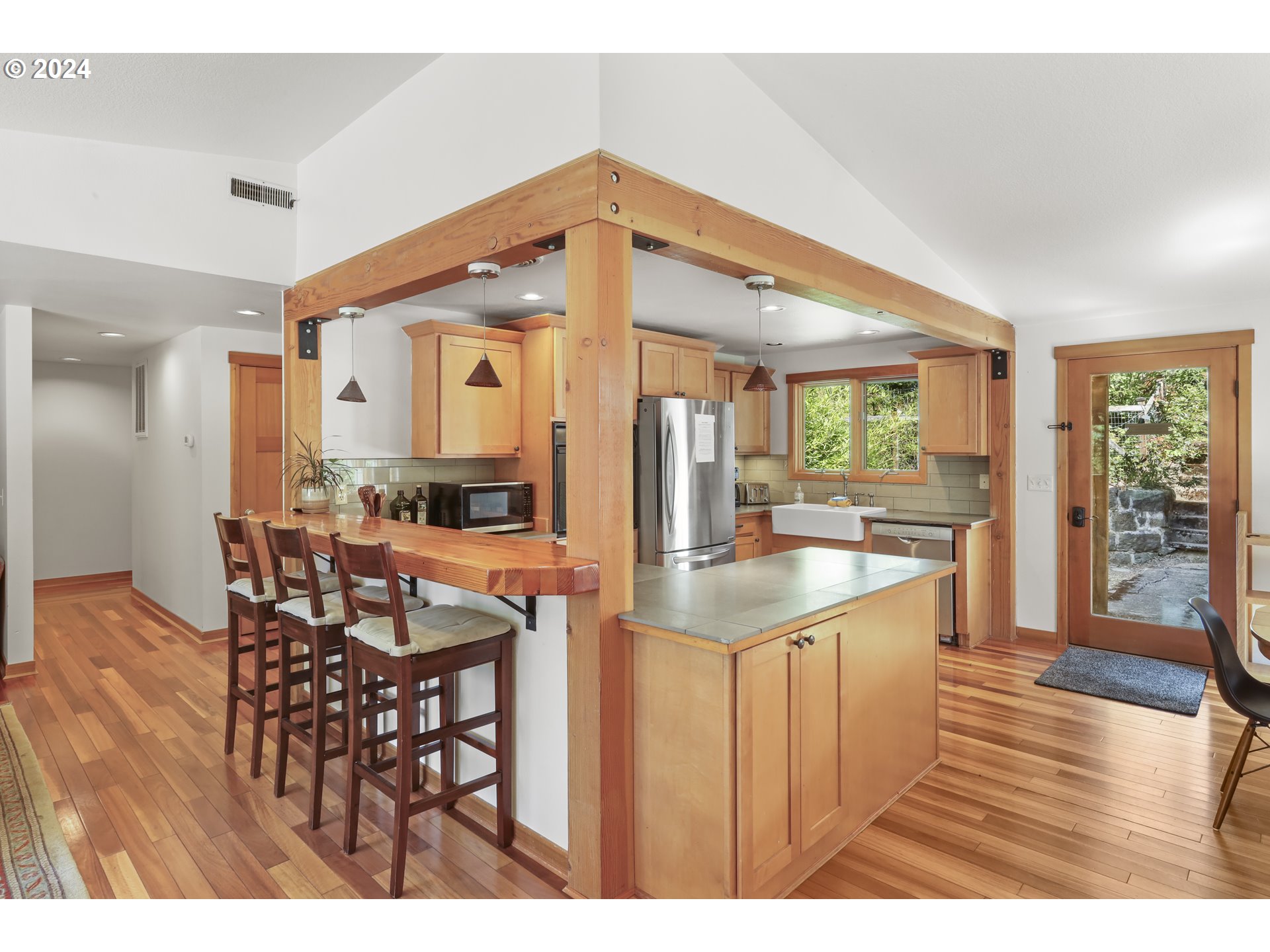7 Rattlesnake Road White Salmon, WA 98672 - Photo 5 of 41 a kitchen with stainless steel appliances kitchen island granite countertop a table chairs and a view of living room