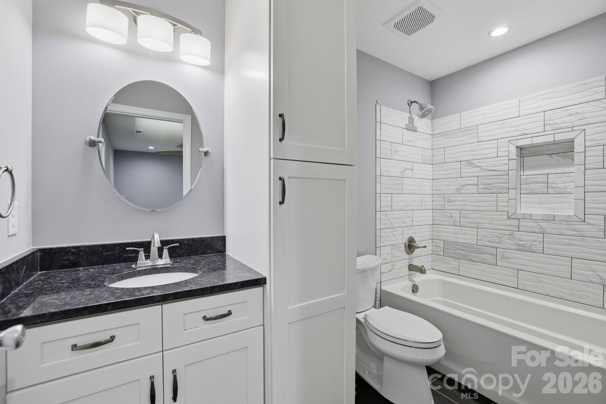 1108 Willoughby Road Monroe, NC 28110 - Photo 11 of 48 a bathroom with a granite countertop toilet sink and mirror