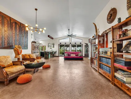 a living room with lots of furniture and a chandelier
