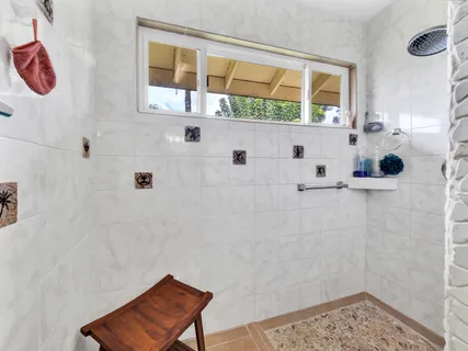a bathroom with a tub sink and mirror