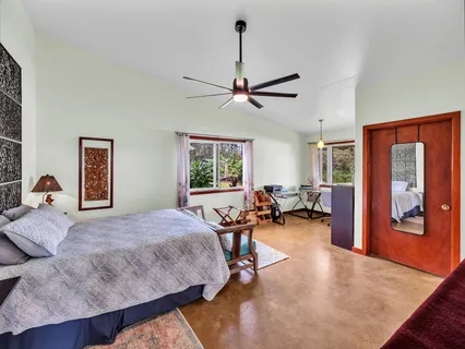 a bedroom with furniture and a large window