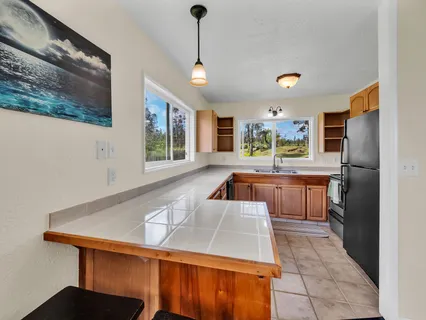 a kitchen with stainless steel appliances granite countertop a sink a stove and a refrigerator