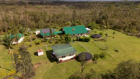a aerial view of a house with yard swimming pool and outdoor seating