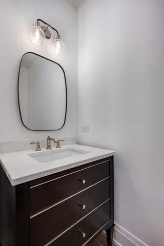 a bathroom with a sink vanity and a mirror