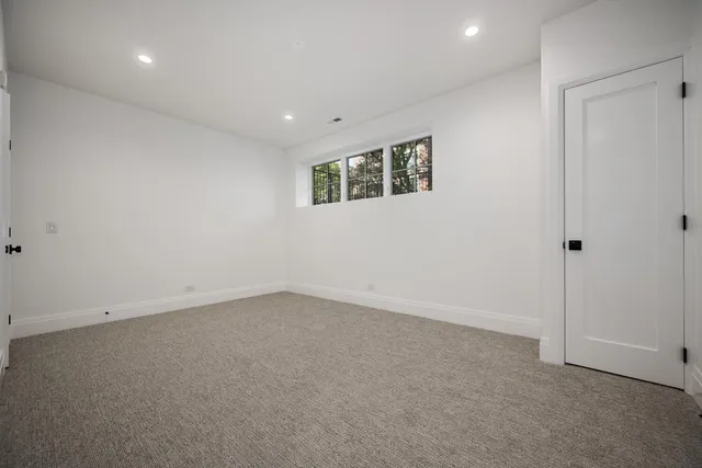 an empty room with a empty space and windows