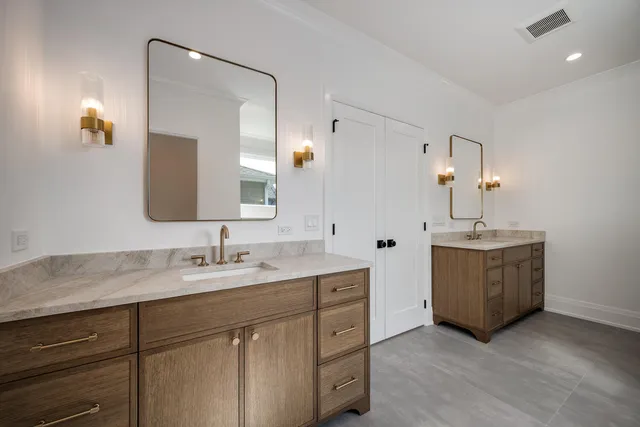 a bathroom with a double vanity sink and a mirror