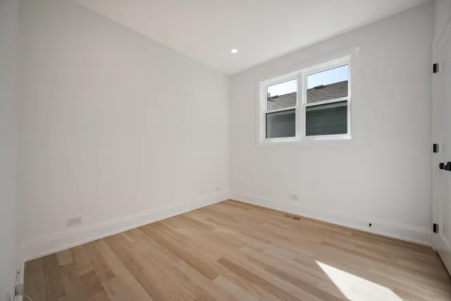 a view of a room with wooden floor and empty room