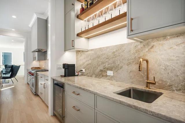 a kitchen with stainless steel appliances granite countertop a sink and a stove