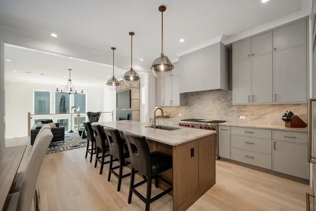 a kitchen with a dining table chairs sink and cabinets