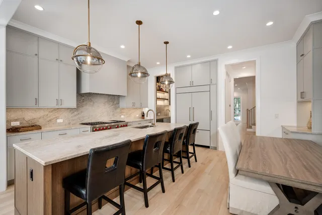 a kitchen with a table chairs refrigerator and microwave