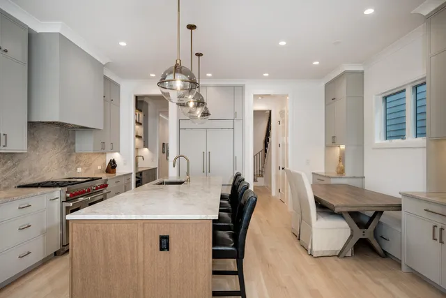 a kitchen with a table chairs refrigerator and cabinets