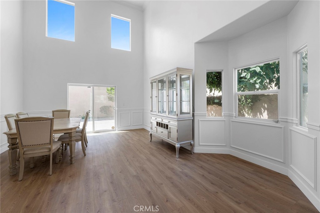 11552 Lower Azusa Road El Monte, CA 91732 - Photo 15 of 41 a dining room with wooden floor and a floor to ceiling window