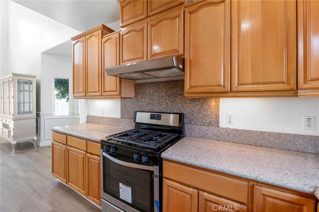 11552 Lower Azusa Road El Monte, CA 91732 - Photo 19 of 41 a kitchen with stainless steel appliances granite countertop a stove a sink and dishwasher