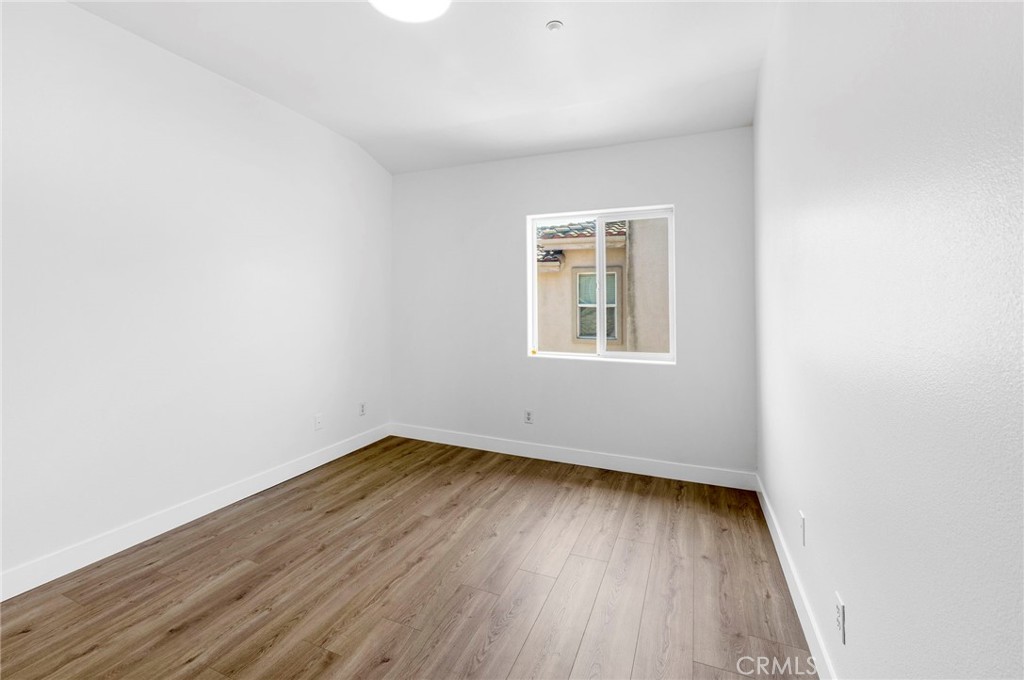 11552 Lower Azusa Road El Monte, CA 91732 - Photo 28 of 41 an empty room with wooden floor and windows