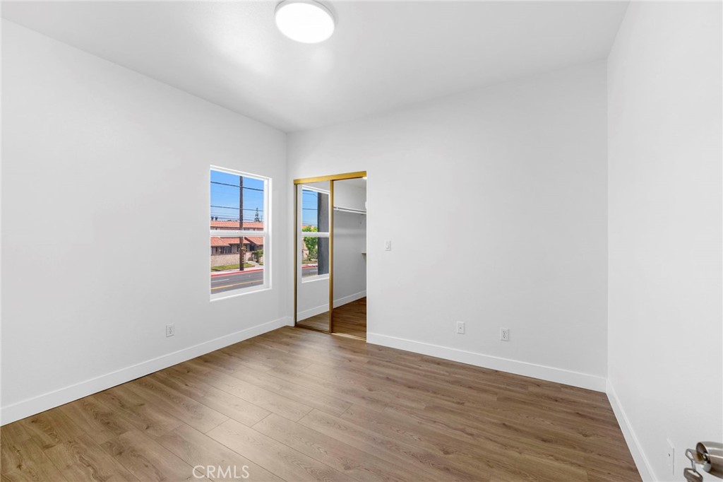 11552 Lower Azusa Road El Monte, CA 91732 - Photo 30 of 41 a view of an empty room with wooden floor and a window