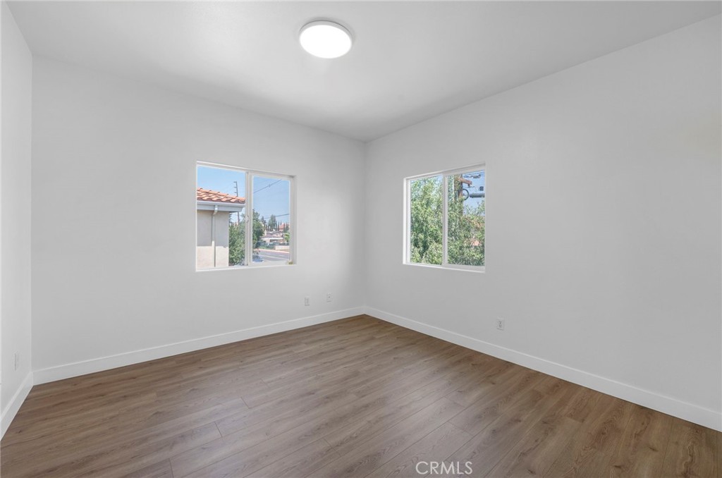 11552 Lower Azusa Road El Monte, CA 91732 - Photo 35 of 41 an empty room with wooden floor and windows