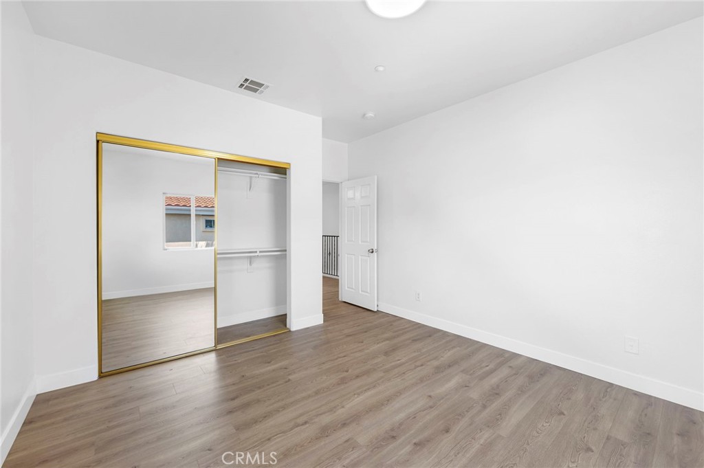11552 Lower Azusa Road El Monte, CA 91732 - Photo 36 of 41 a view of empty room with wooden floor and kitchen
