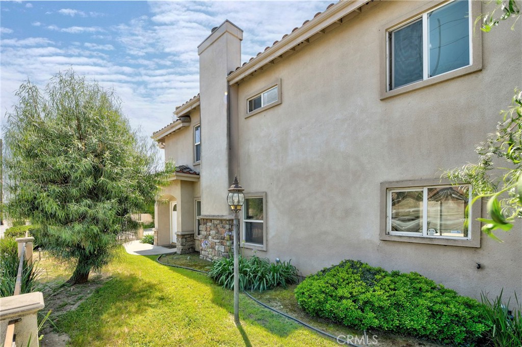 11552 Lower Azusa Road El Monte, CA 91732 - Photo 40 of 41 front view of a house with a yard and potted plants