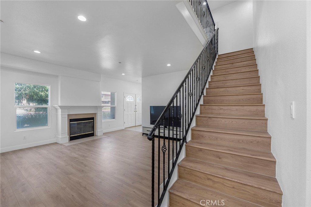 11552 Lower Azusa Road El Monte, CA 91732 - Photo 6 of 41 a view of a hallway with wooden floor fireplace and stairs