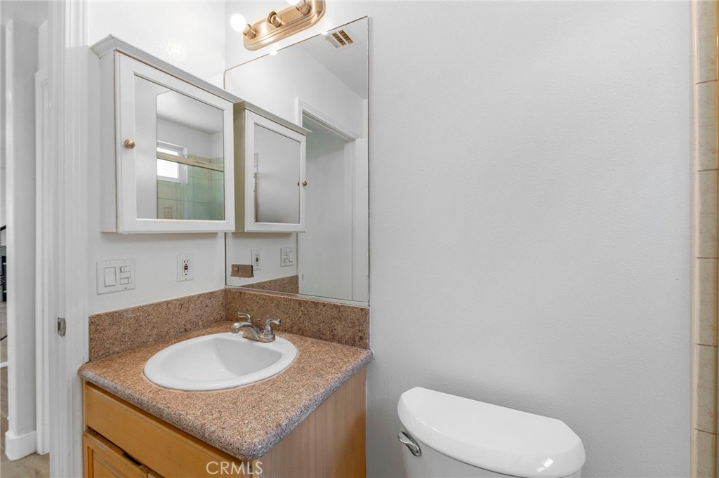 11552 Lower Azusa Road El Monte, CA 91732 - Photo 10 of 41 a bathroom with a granite countertop toilet sink and mirror