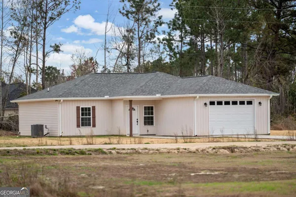 a house that has a tree in front of it
