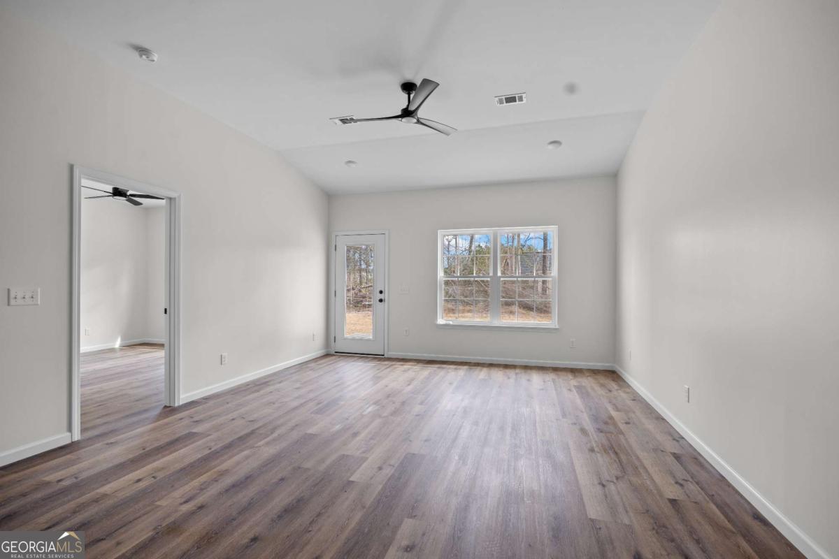 96 Beech Road Hazlehurst, GA 31539 - Photo 19 of 32 wooden floor in an empty room with a window