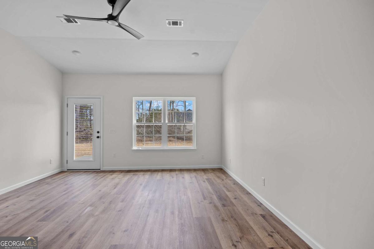 96 Beech Road Hazlehurst, GA 31539 - Photo 20 of 32 wooden floor in an empty room with a window