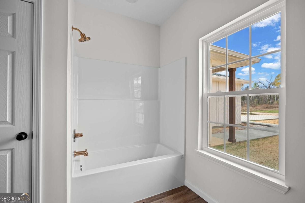 96 Beech Road Hazlehurst, GA 31539 - Photo 23 of 32 a bathroom with a bathtub and a shower